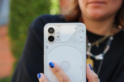 Phone (1) is a little transparent, but you can’t see its inner workings.