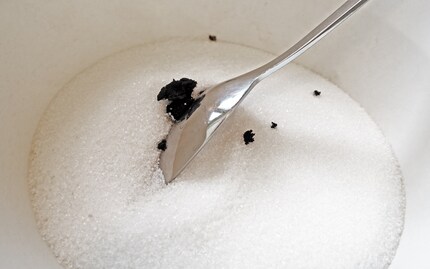 The best way to add vanilla seeds into a bowl is to wipe them off the knife with a spoon.