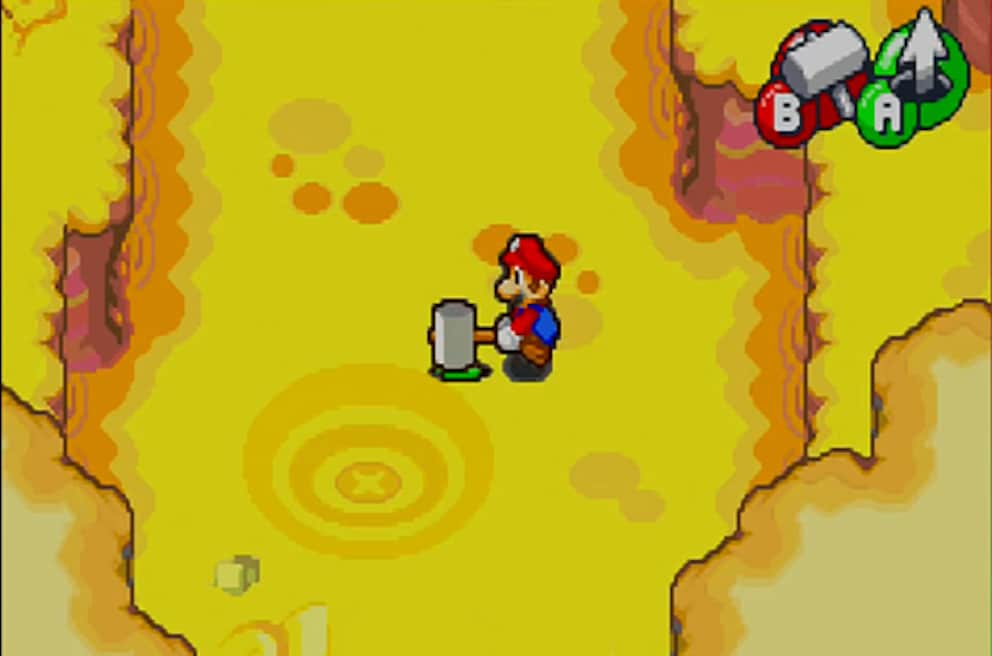 Mit dem Hammer rammt Mario seinen Bruder in die Erde, damit dieser nach vergrabenen Schätzen sucht. Lustig.