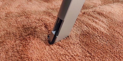 The cable «flows» through a small channel behind the TV to a stand and from there to the floor.