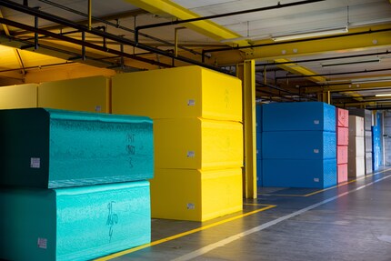 Numerous brightly coloured foam blocks in the warehouse.