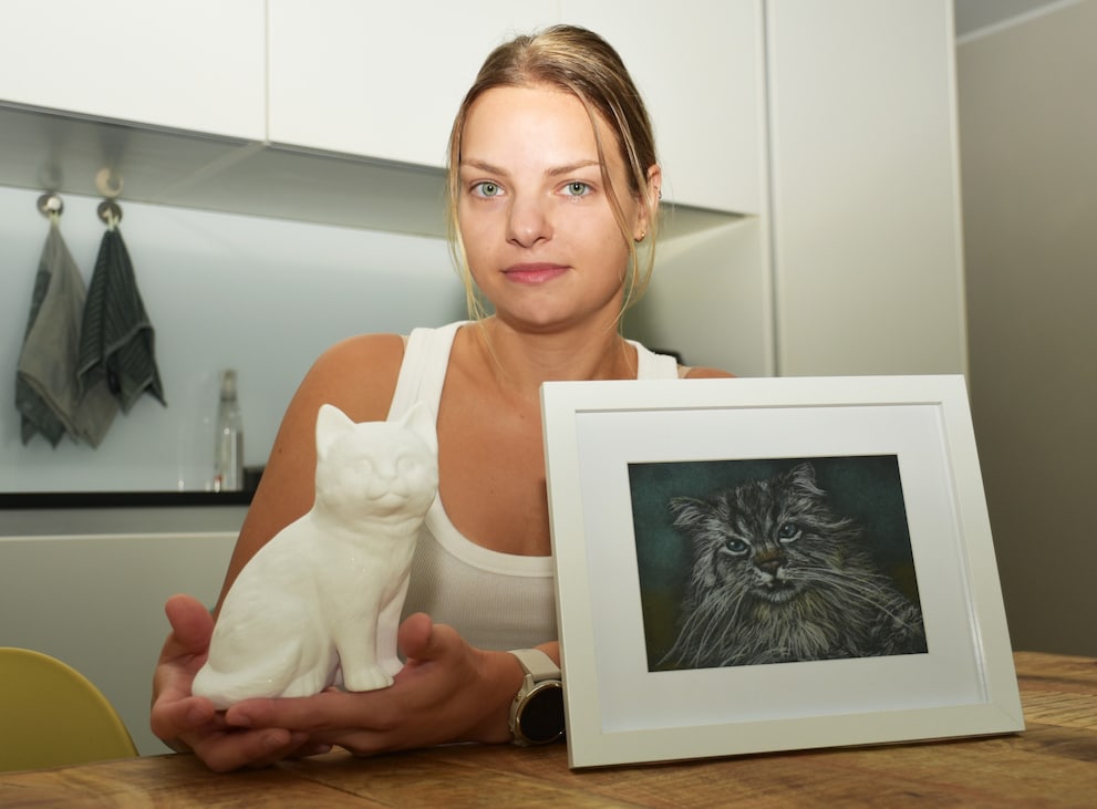Veronica’s mementos of Loki: his cat-shaped urn and a portrait, drawn by her mother.