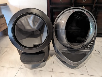 On the left, the new Litter Robot 4 with a larger opening and brighter interior.