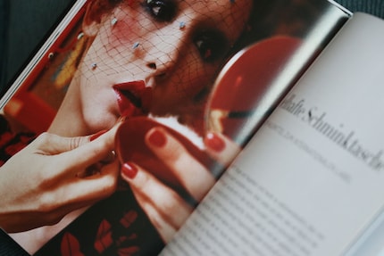 Regelmatig je lippenstift controleren in de spiegel is een must, want rode lippenstift heeft de neiging een eigen leven te gaan leiden. Afbeelding uit het boek «Face Paint» van Lisa Eldridge.
