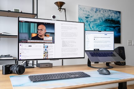 An office setup with the Samsung Odyssey OLED G8 and a MacBook as a second screen.