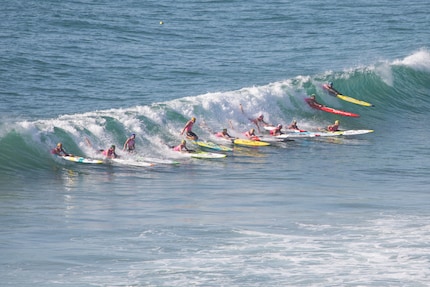 Powering through the surf: prone paddling competitions are popular in Australia.