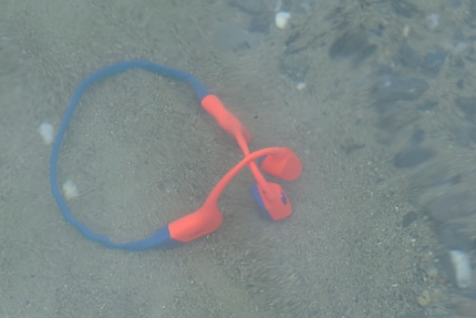 The headphones lying on the sandy bottom of the lake. Fortunately, I tested their buoyancy in knee-deep water.