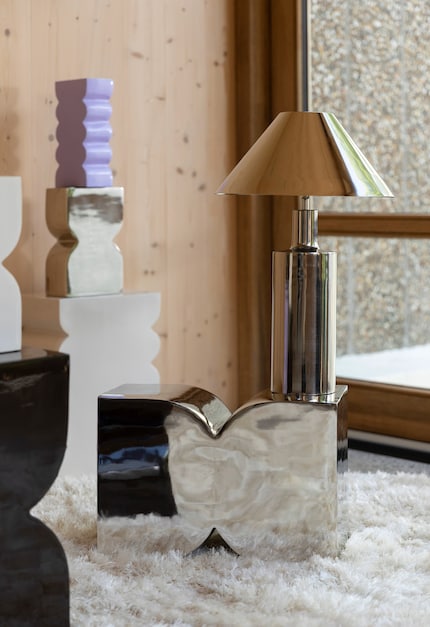 Here, mirrored, cool designs are warmed up with furs and wooden furniture.
