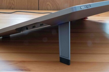 On the side: two USB-C ports for power and devices; on the top: touch slider and power button.