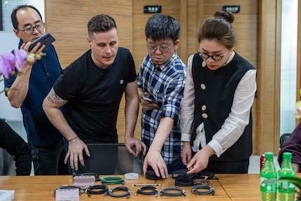 Kevin (in checked shirt) and Yannick look at possible USB-C cables.