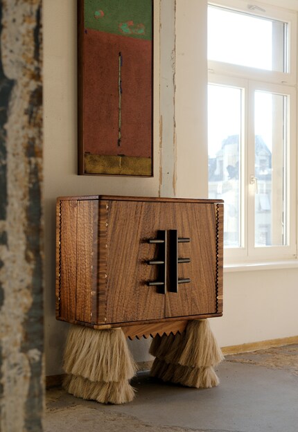 Comité de Proyectos’ wooden cabinet Carmen symbolises the instinctive act of giving and receiving care.